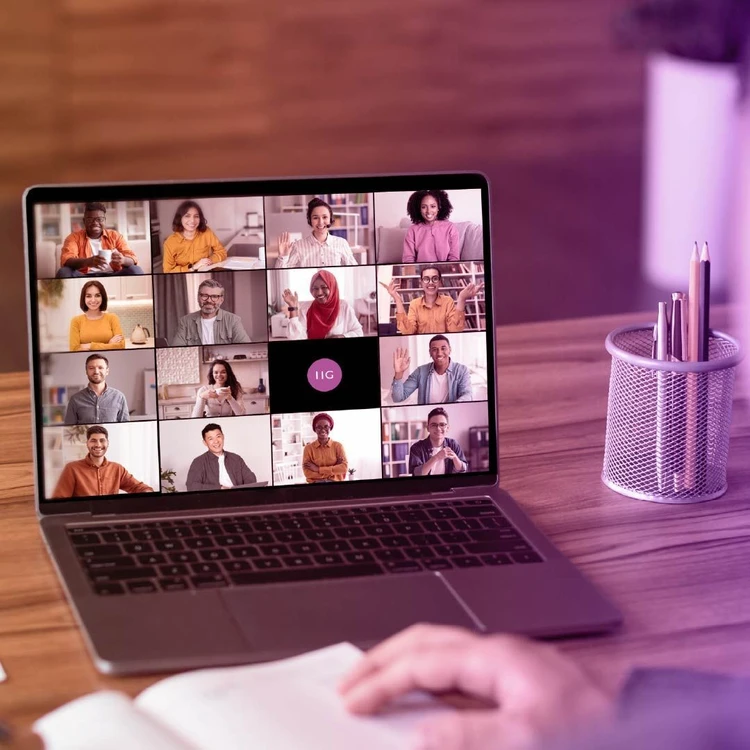 Laptop displaying professionals engaged in an online work meeting.